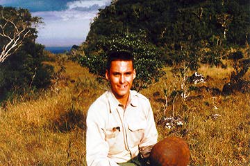 Jerry Long holding Japanese helmet on side of Mt. Pinatubo.